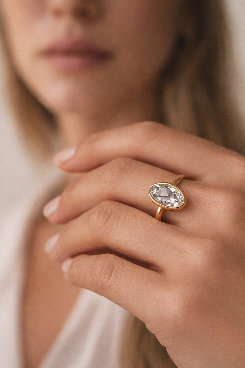 Side-by-side profile view comparison showing bezel setting flush against finger versus prong setting elevated 5mm above band, both featuring 2-carat round brilliant diamonds - Instantly visualizes the "snag-free" advantage that text alone cannot convey