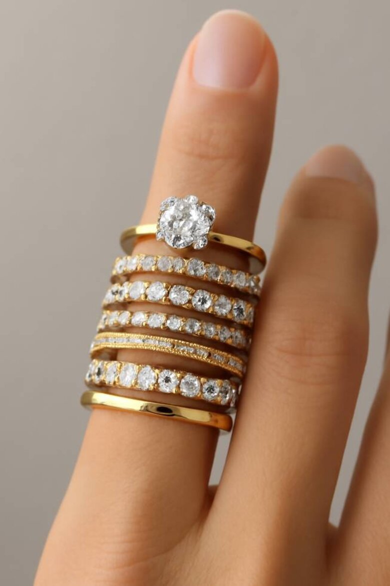 Image: Seven-Ring Stackable Wedding Set on Hand Showcasing Mixed Metals and Progressive Design - Demonstrates how lab-grown diamond bands create visual storytelling from engagement through major anniversaries